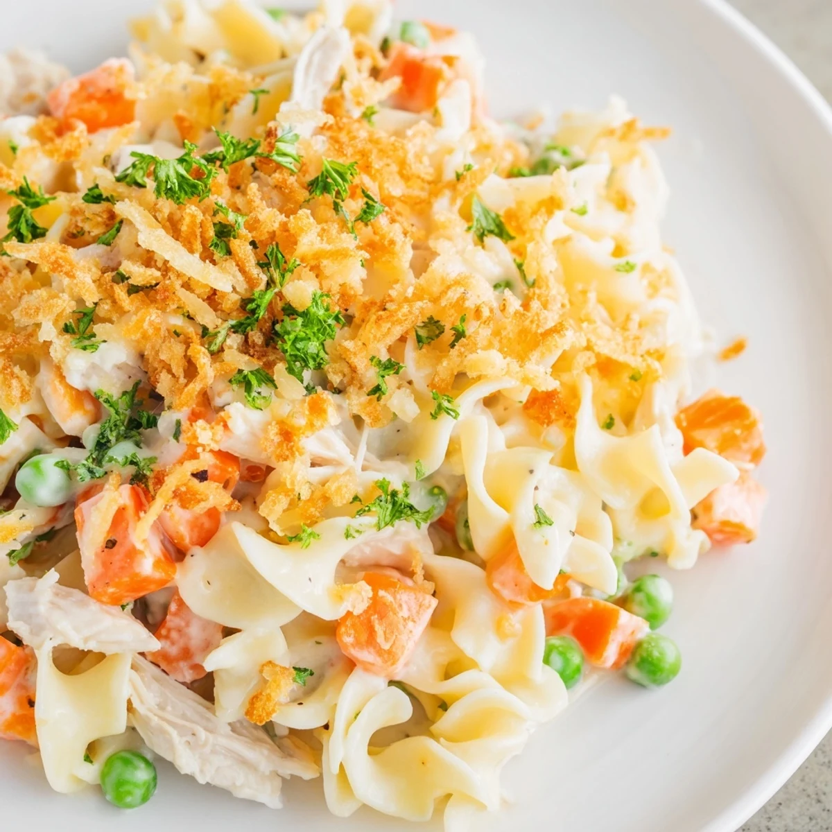 Golden, buttery crumble topping on a creamy Chicken Noodle Casserole with tender vegetables.