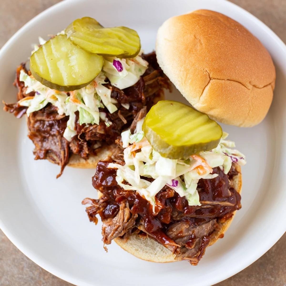 Juicy slow-cooked beef brisket sliders topped with crisp coleslaw and pickles, perfect for a party or game day snack.