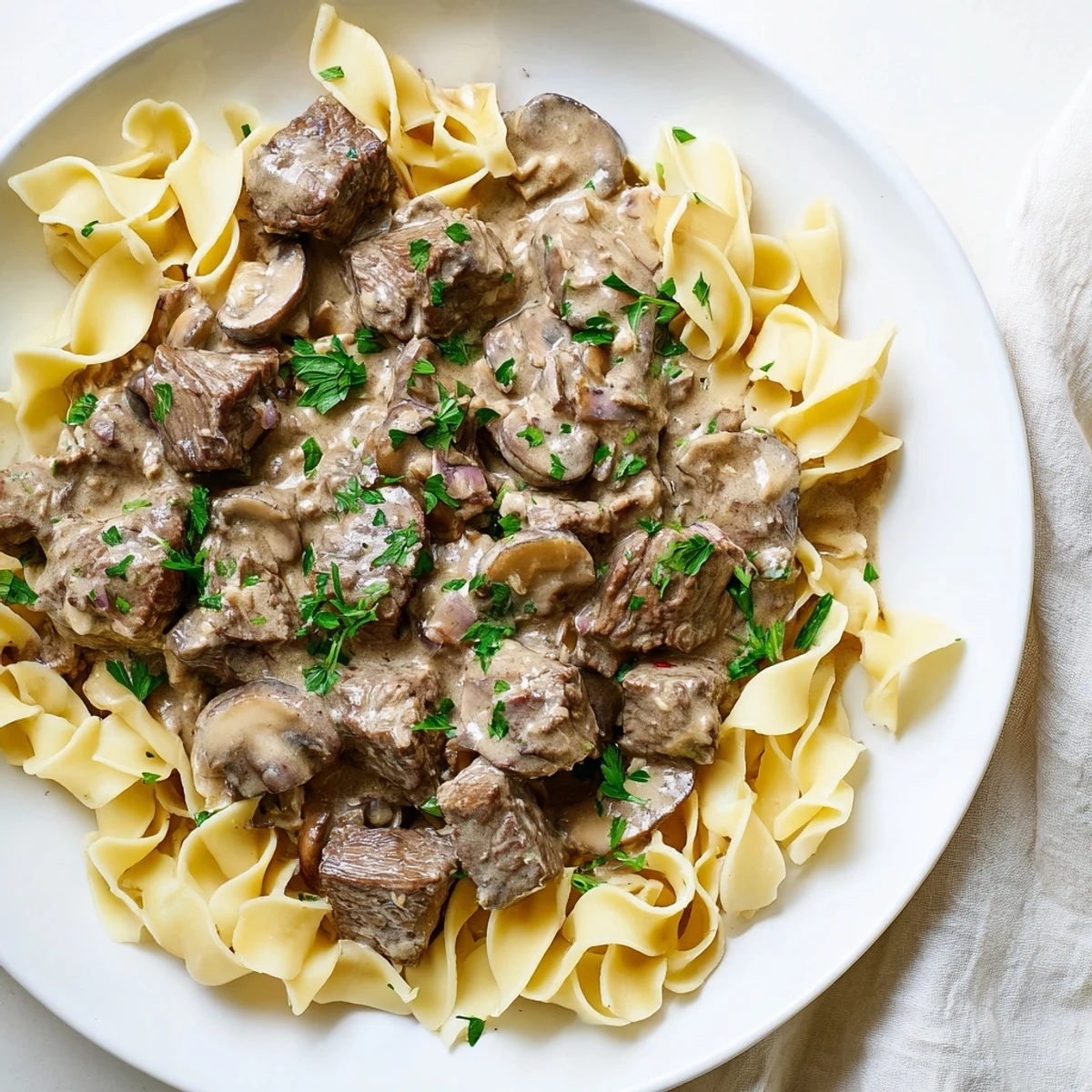Tender beef strips and creamy mushroom sauce atop buttery egg noodles in Beef Stroganoff with Egg Noodles.