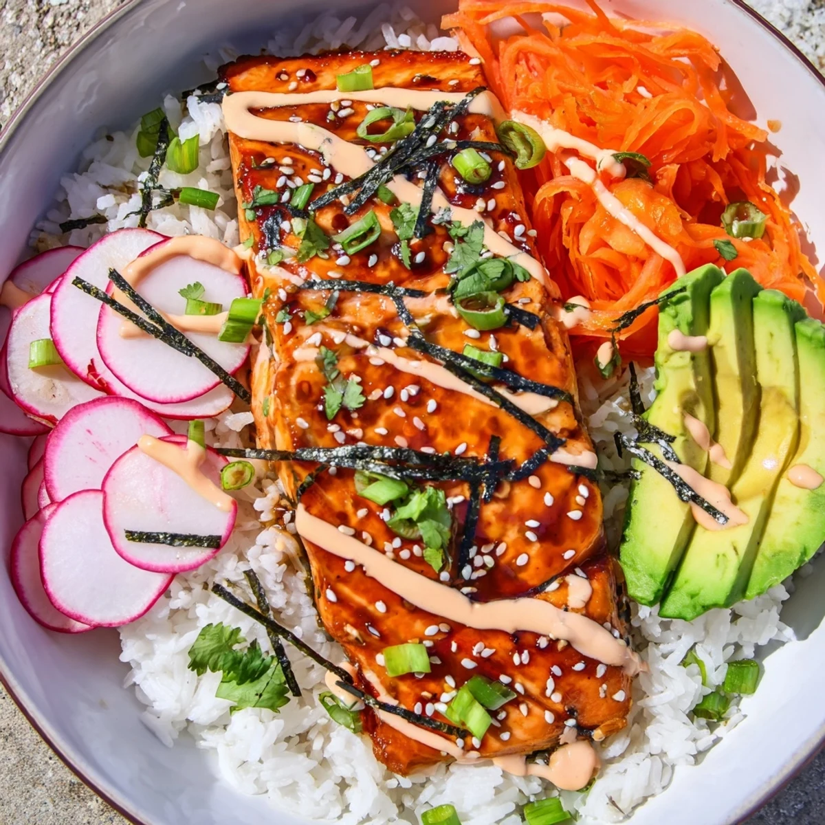 Fresh cilantro and toasted sesame seeds garnish this colorful Teriyaki Salmon Rice Taco Bowl with creamy avocado and zesty sriracha mayo.