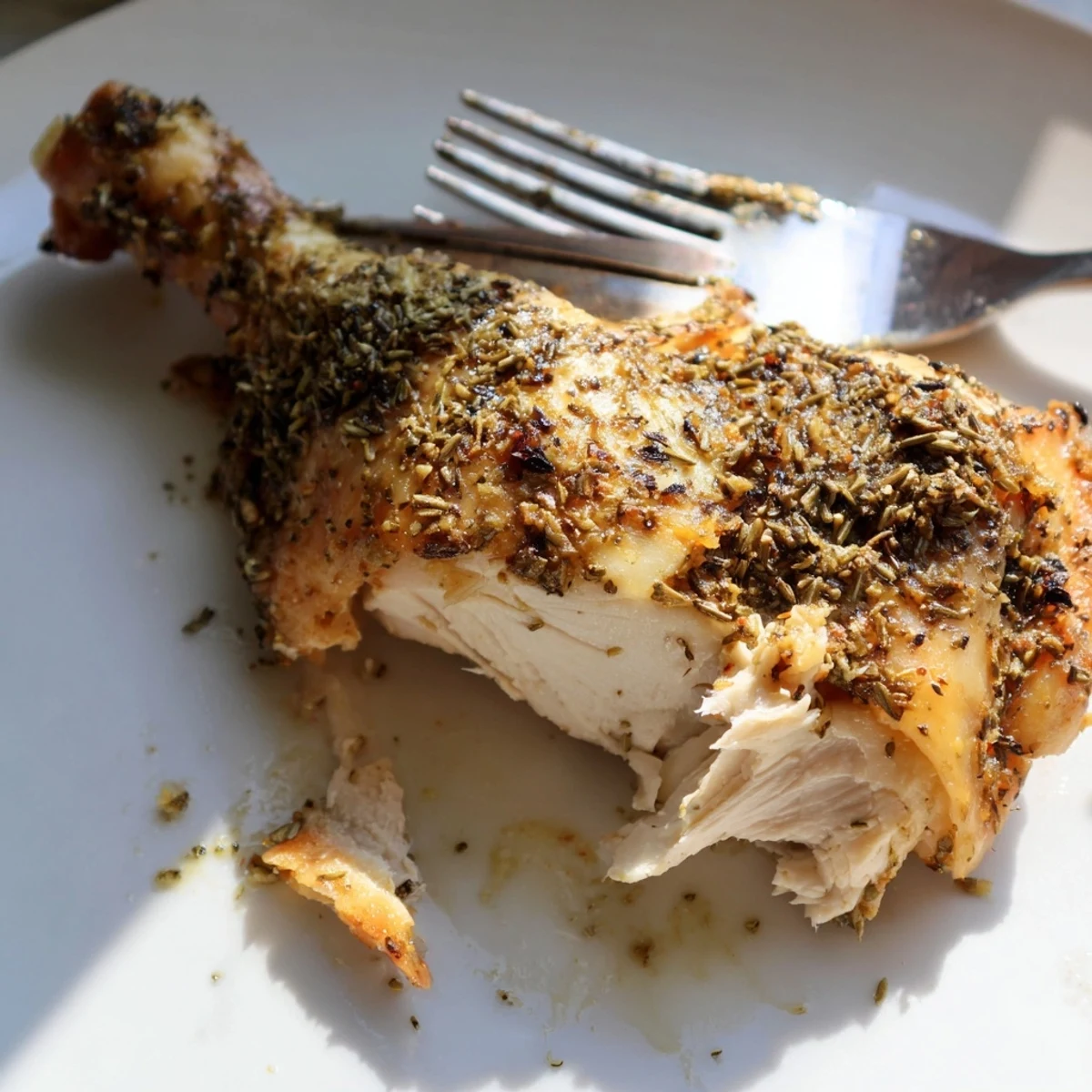 Golden roasted zaatar chicken glistening with olive oil and lemon, served with caramelized carrots and red onions on a rustic platter.