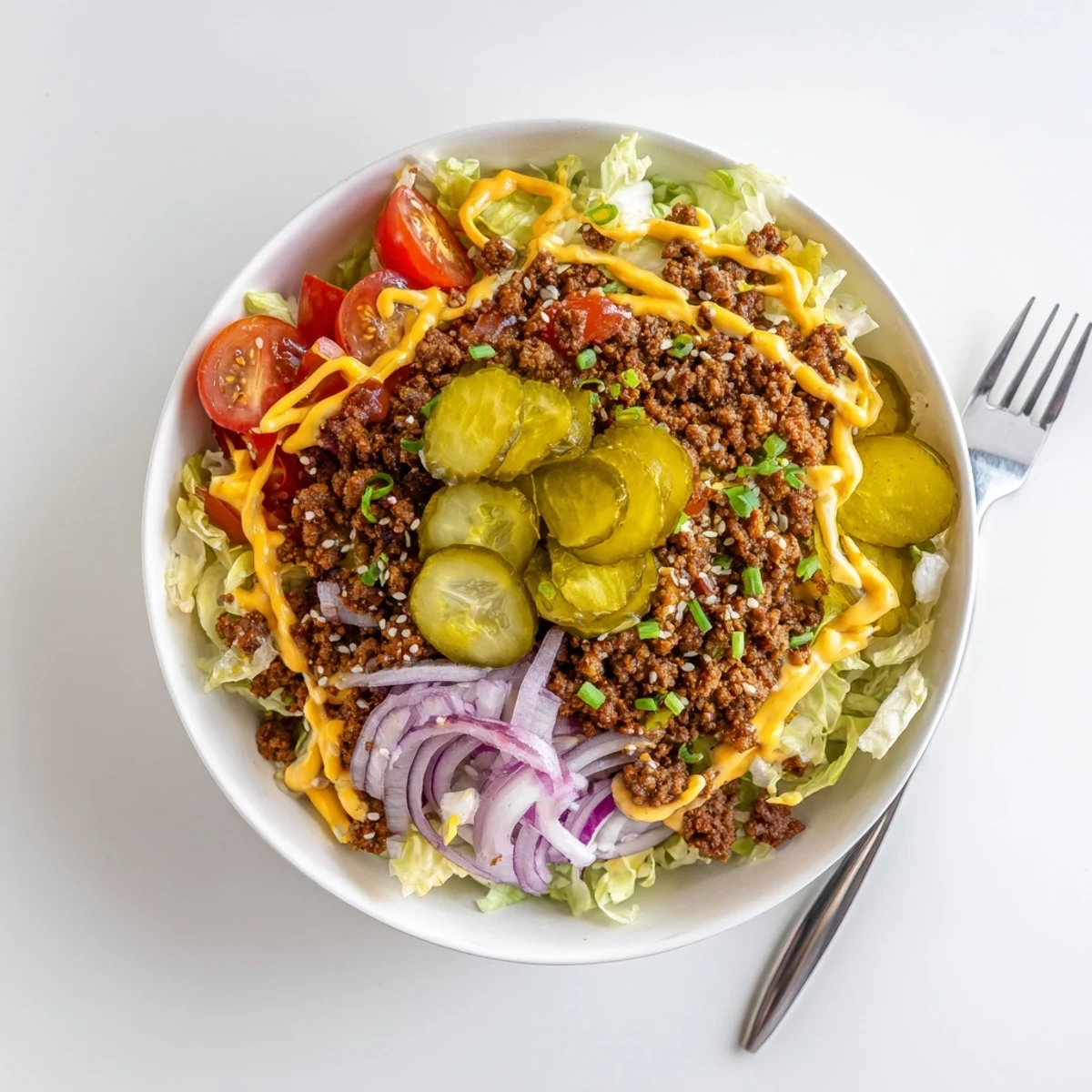 A vibrant Smash Burger Bowl featuring melted cheddar, crumbled bacon, fresh cherry tomatoes, and sesame seeds, served chilled for an easy weeknight dinner.