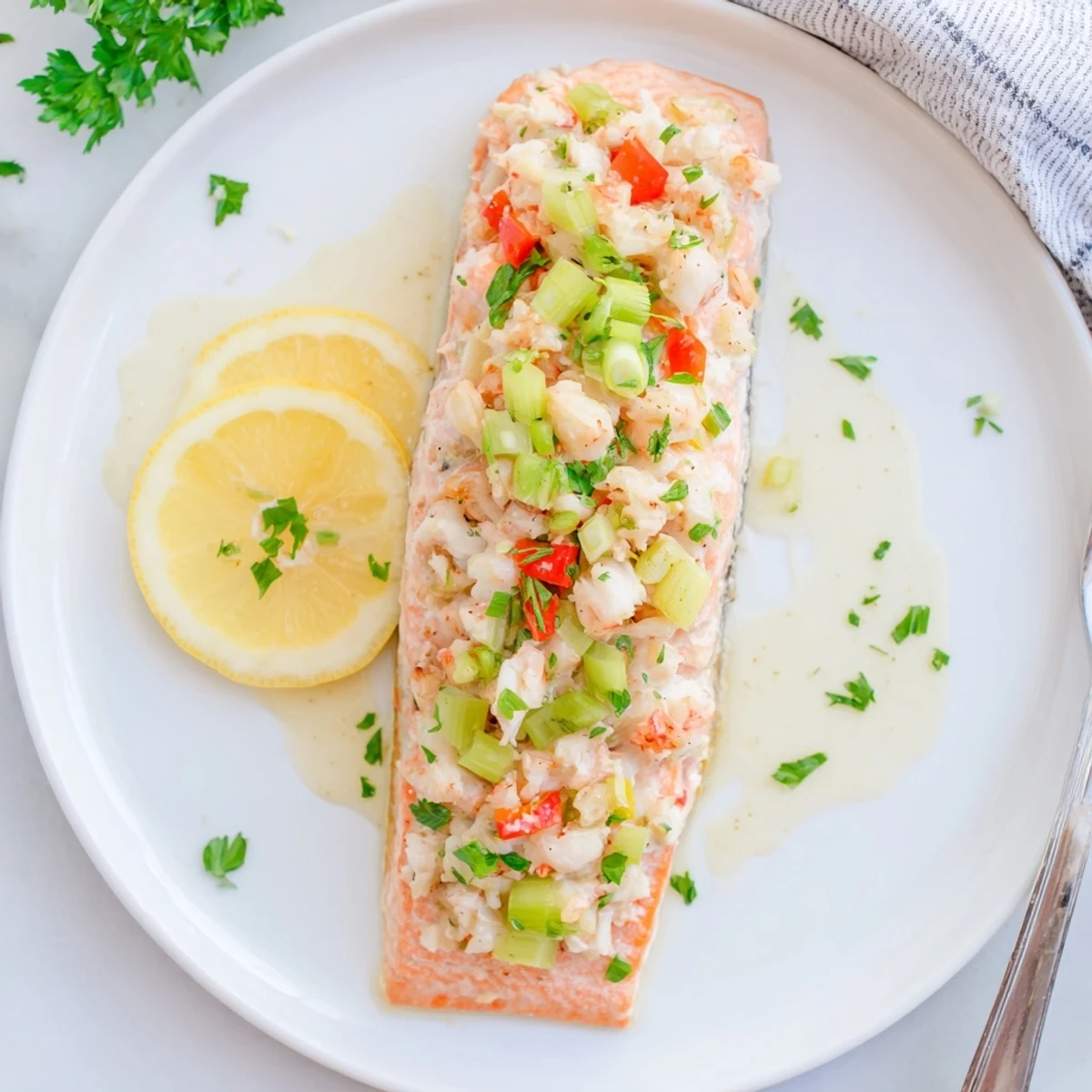 Close-up of Crab & Shrimp Stuffed Salmon revealing tender crab and shrimp mixture inside the moist salmon pocket, garnished with fresh parsley.