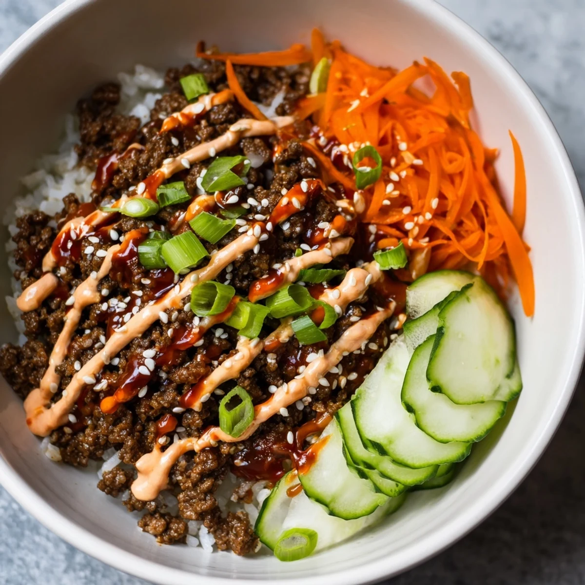 Korean Beef Bowl with Spicy Mayo offers a forkful of savory beef, crisp vegetables, and spicy mayo, plated with sesame seeds for an easy weeknight dinner.