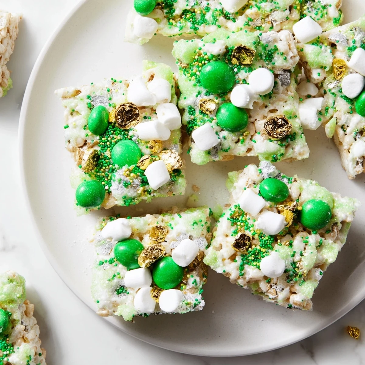 Sweet white chocolate Lucky Chow dessert topped with mini marshmallows and green candy-coated chocolates for St. Patricks Day celebrating
