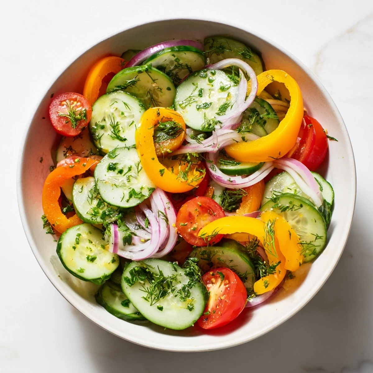 Vibrant cucumber and sweet pepper salad featuring red onions parsley and dill for refreshing flavor