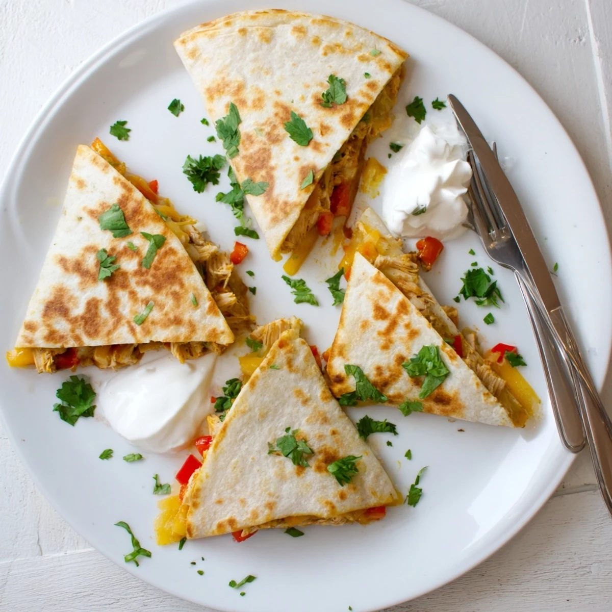 Golden crispy chicken quesadillas filled with melted cheese and colorful diced vegetables