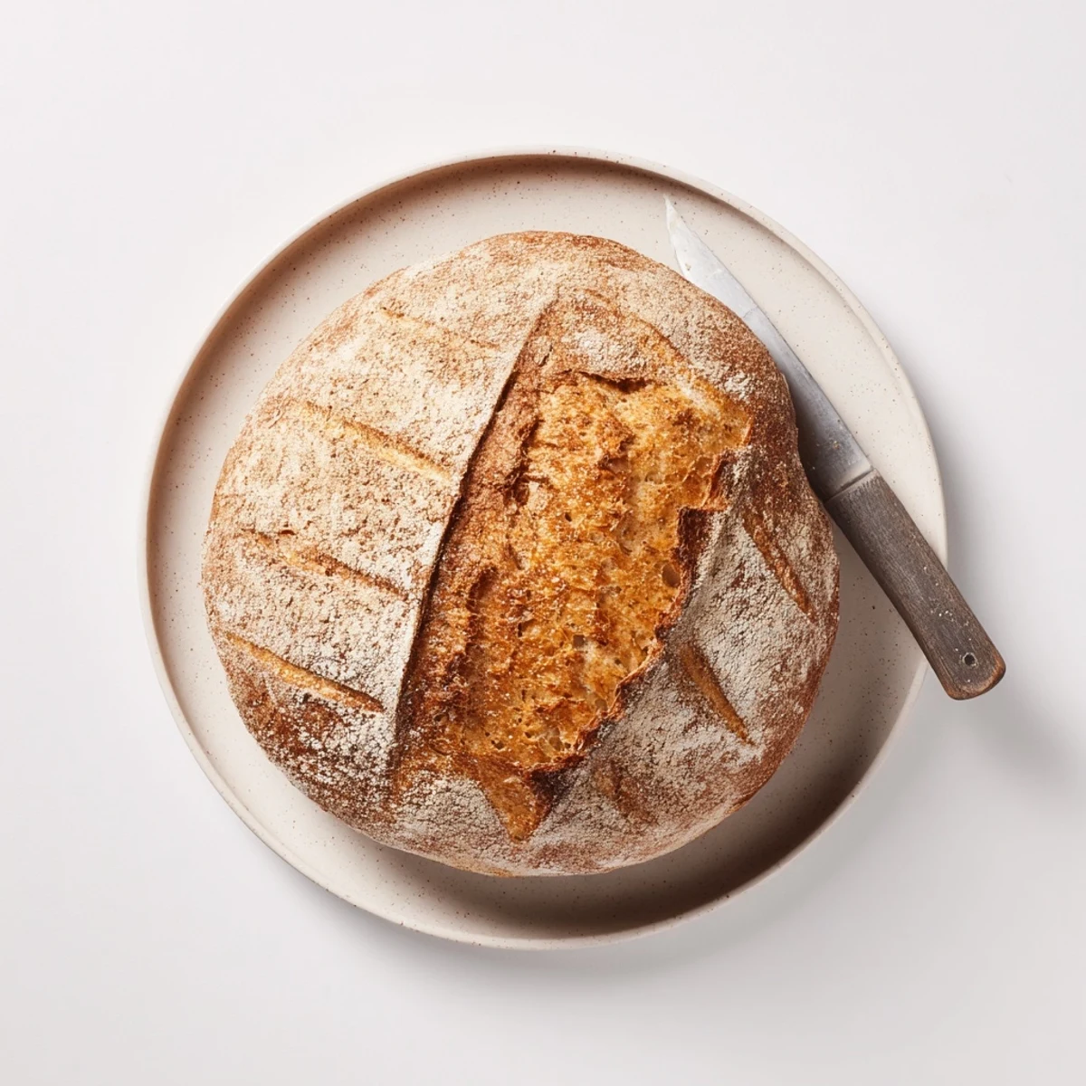 Homemade easy rustic bread cooling on wire rack with perfect golden brown crusty exterior
