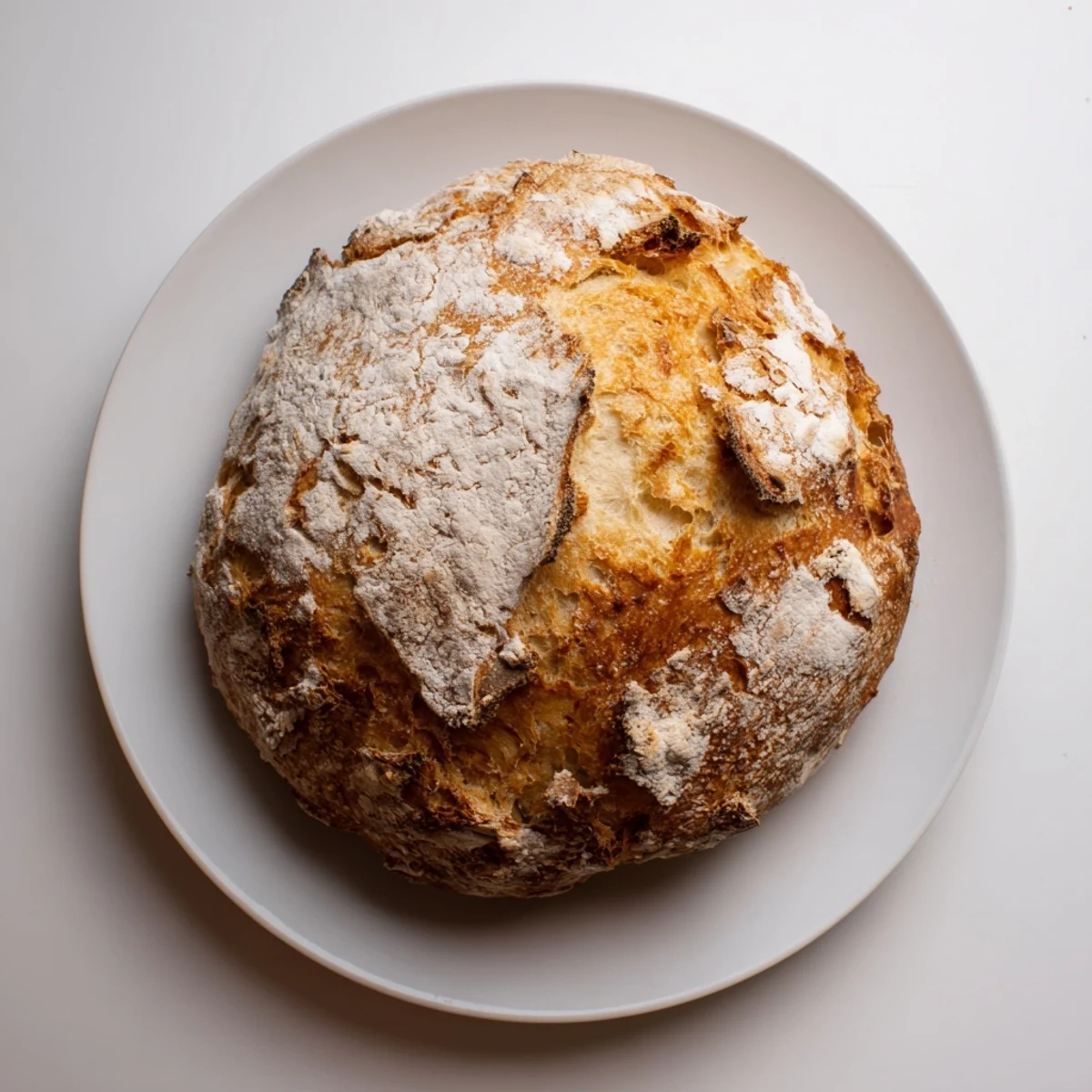 Freshly baked no knead bread loaf cooling on wire rack with thick crispy exterior