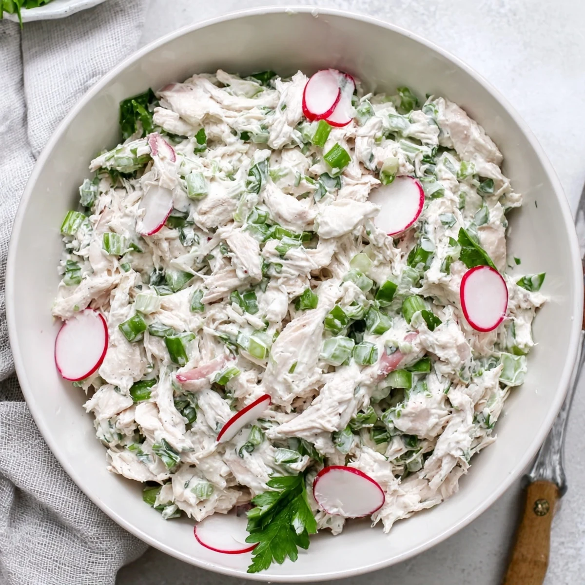 Tangy Green Goddess Chicken Salad Dip plated with fresh vegetables and toasted bread for dipping