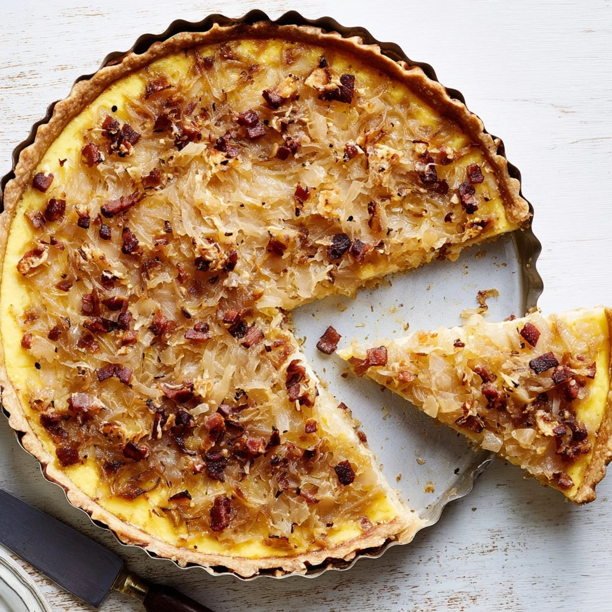 Homemade German onion pie featuring tender onions baked in rich egg custard on buttery crisp pastry