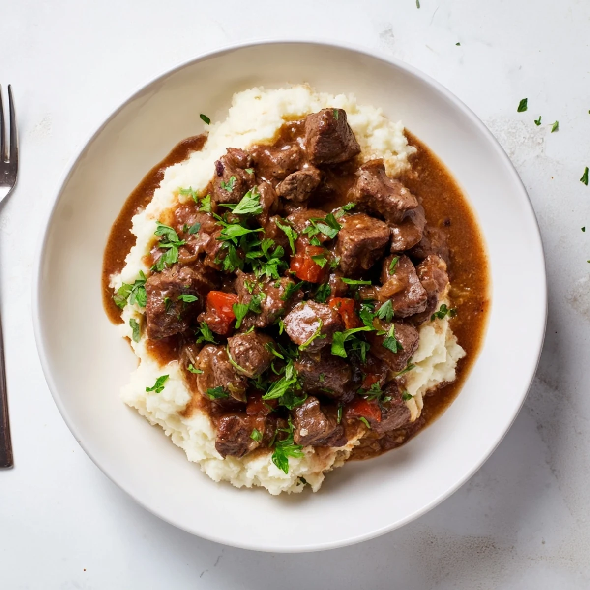 Tender beef tips simmering in rich brown gravy alongside buttery egg noodles for a comforting dinner