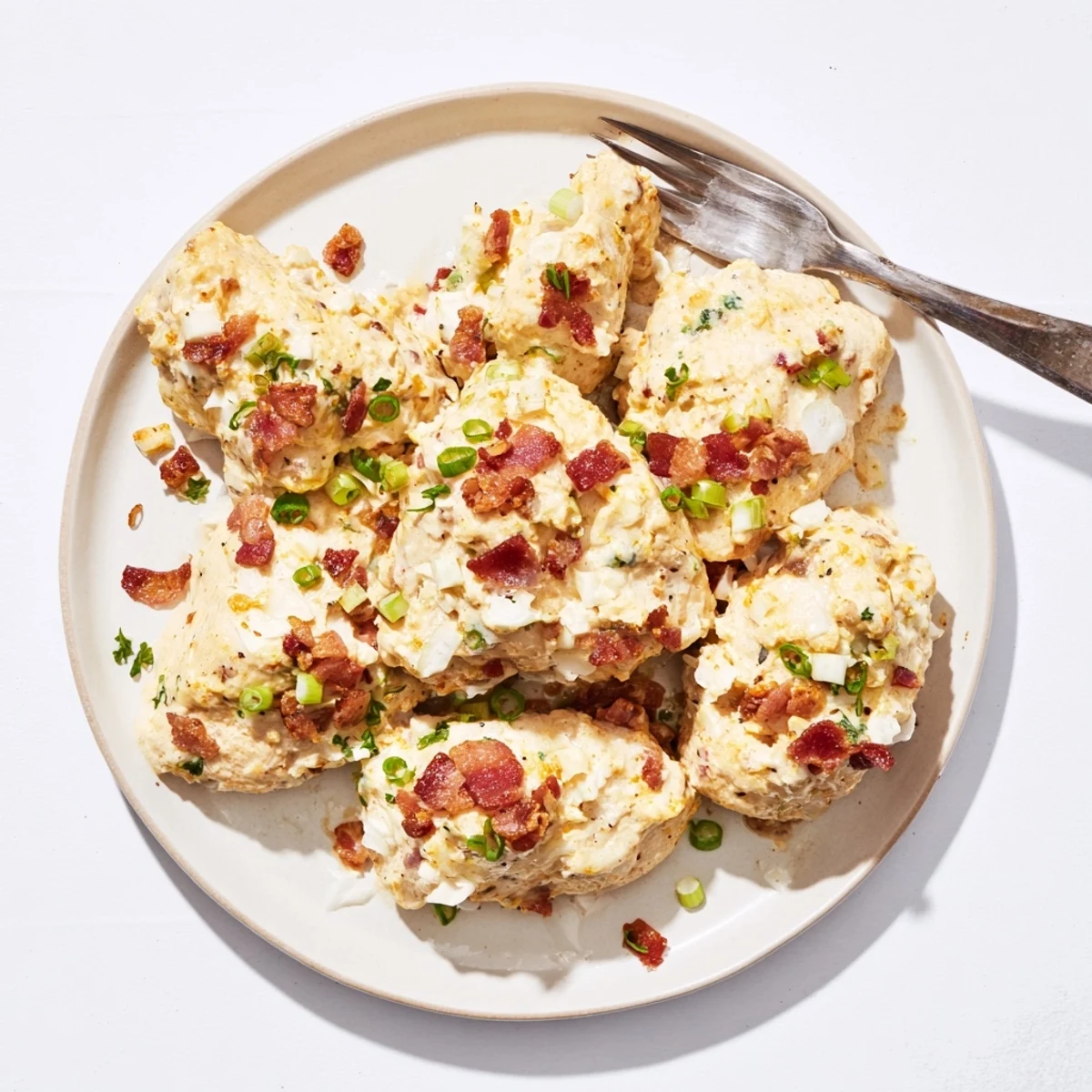 Creamy slow cooker Crockpot Million Dollar Chicken garnished with fresh parsley and savory bacon bits