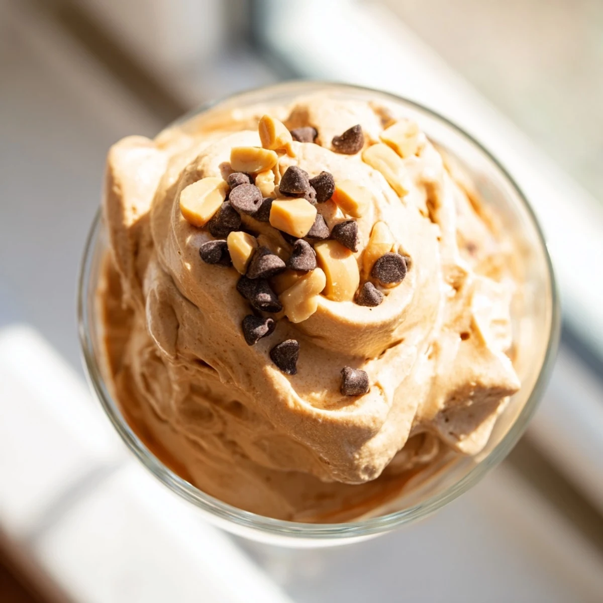 Creamy peanut butter and Cool Whip mousse topped with chocolate shavings in glass bowls