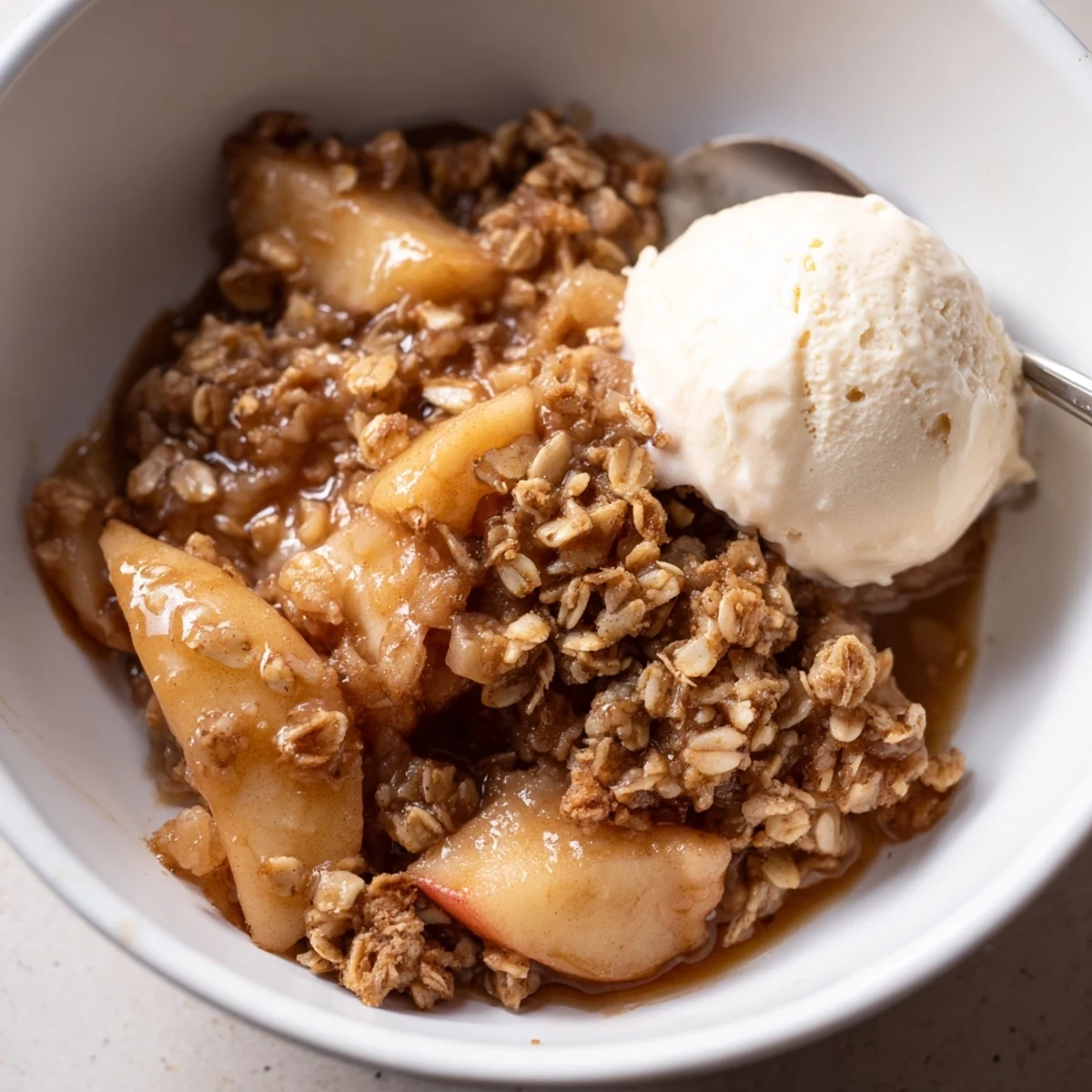 Crockpot apple crisp bubbling with tender cinnamon apples under a buttery crumb crust