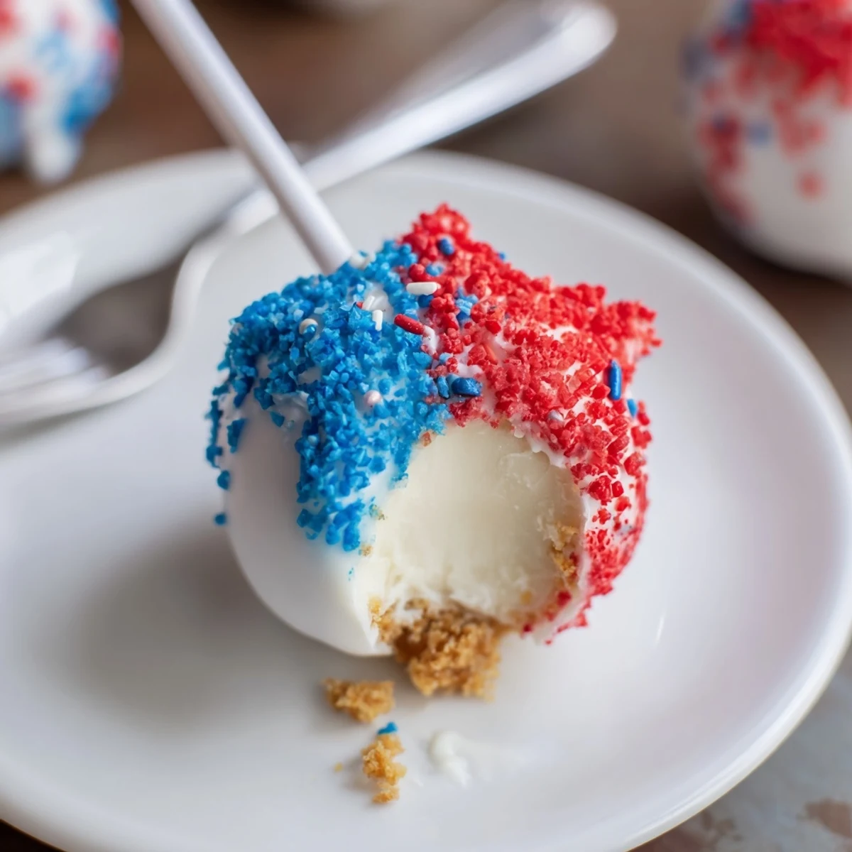Chilled Fourth Of July Star Cheesecake Pops dipped in glossy colored chocolate, ready