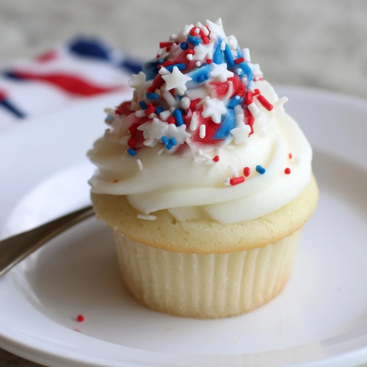 Plated Patriotic Firework Cupcakes ready for Fourth of July with sparkling topper