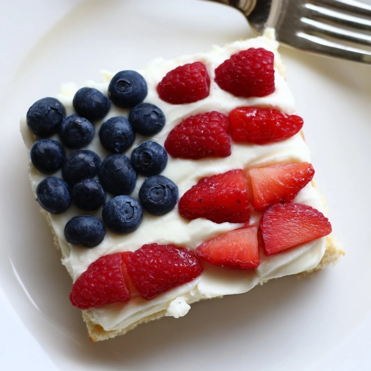 Sugar Cookie Flag Fruit Pizza topped with glossy blueberries and sliced strawberries