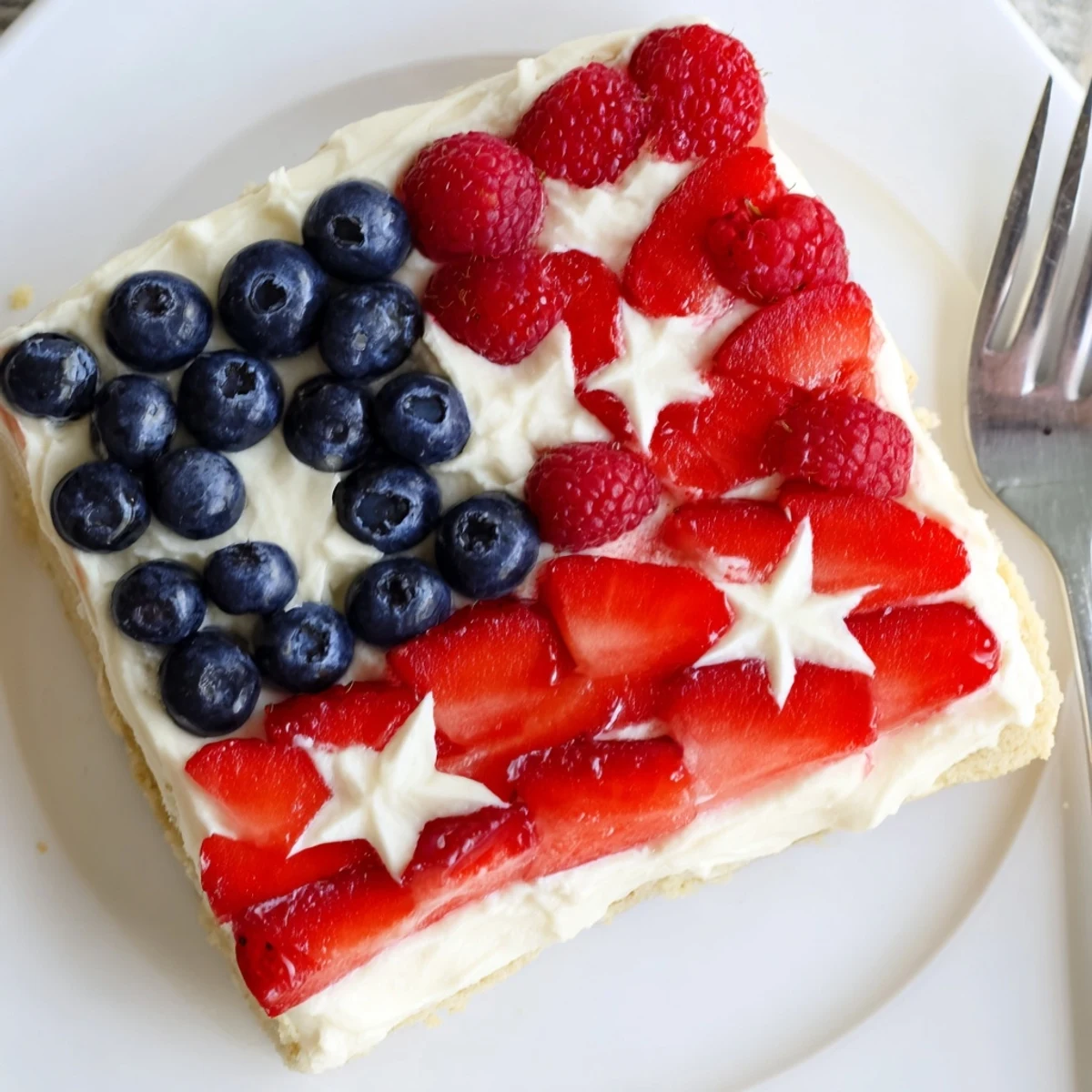 Chilled Sugar Cookie Flag Fruit Pizza on parchment, creamy frosting and berries