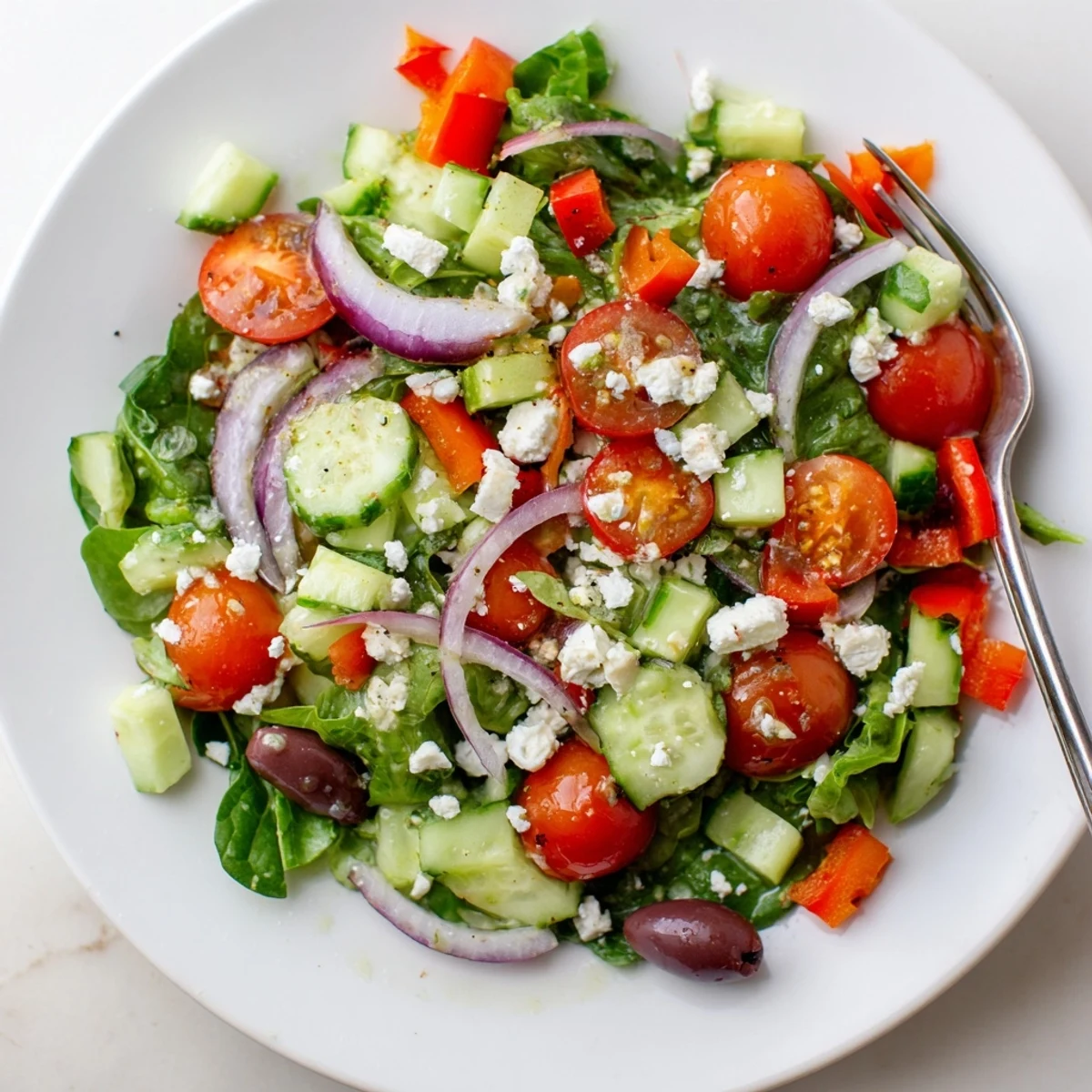 Colorful Fresh Salad Recipe served in a bowl with crunchy cucumbers.