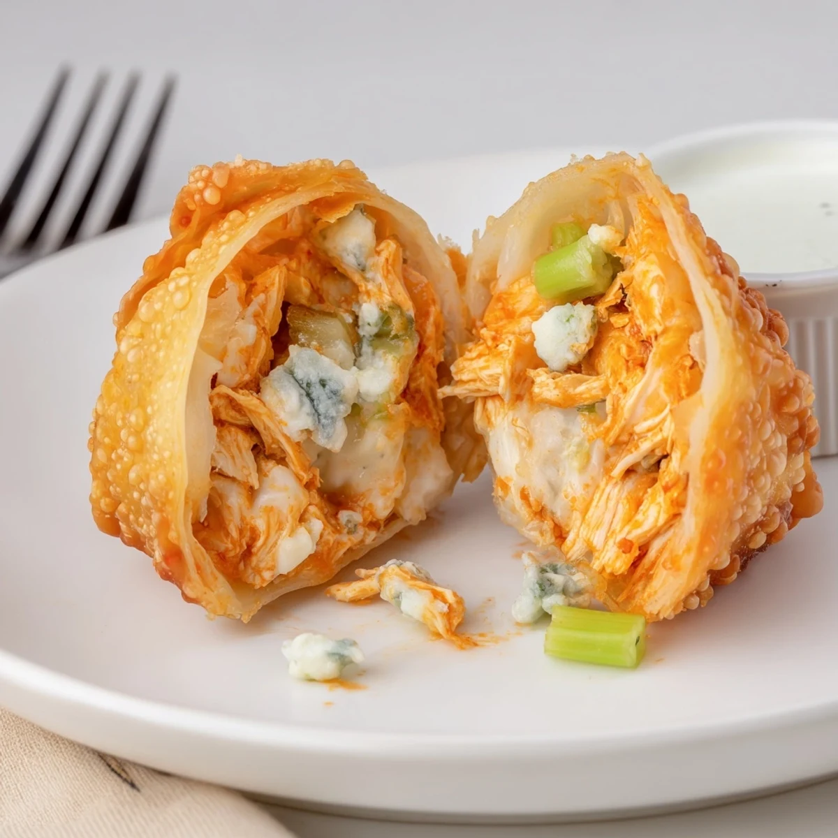 Crispy golden Buffalo Chicken Egg Rolls Recipe, spicy cheesy filling served with ranch