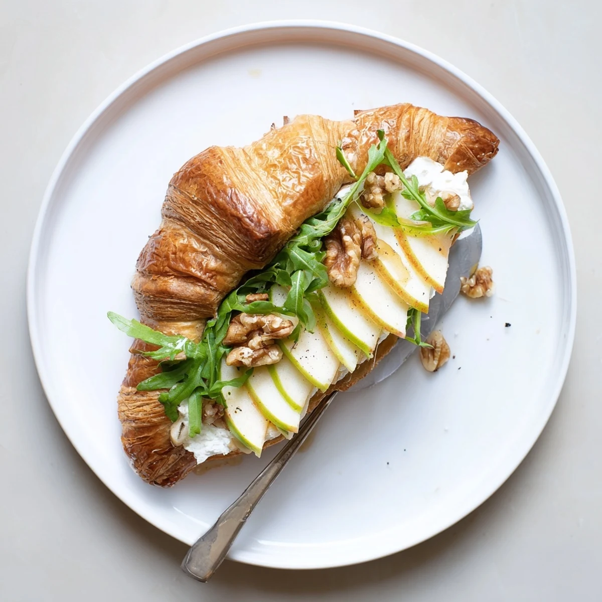 Buttery Apple Goat Cheese Croissant Sandwich layered with crisp apples and arugula