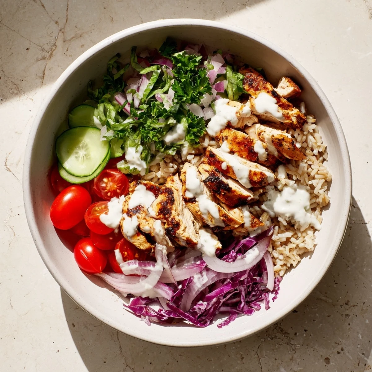 Nutritious Middle Eastern inspired bowl packed with protein rich spiced chicken over a bed of greens and wholesome grains