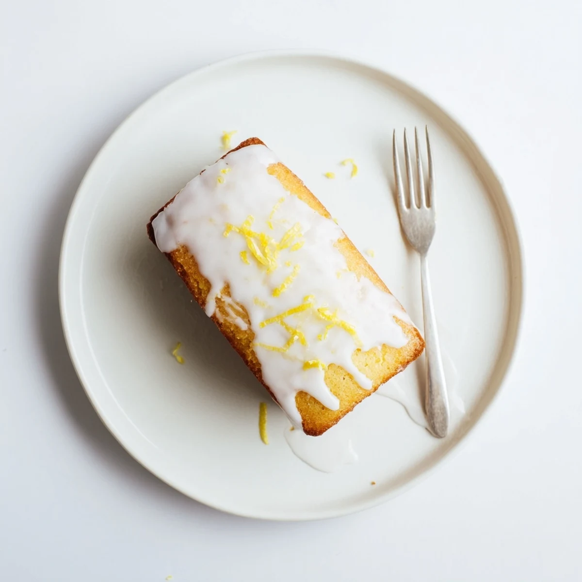 Moist lemon loaf cake sliced to reveal tender crumb topped with sweet lemon icing