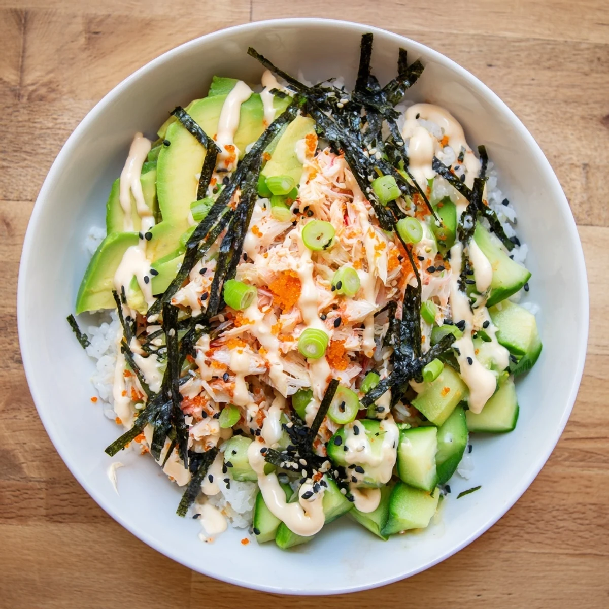 Deconstructed California roll sushi bowl features seasoned rice topped with fresh diced vegetables