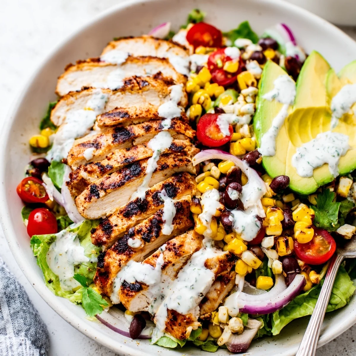 Grilled Southwestern Chicken Salad with charred corn, ripe avocado, zesty lime dressing