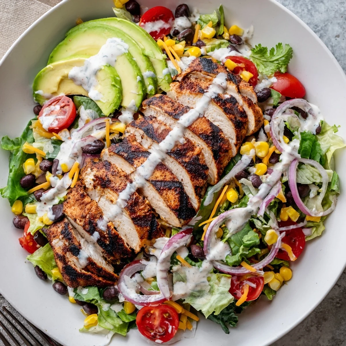 Bright Southwestern Chicken Salad piled high with grilled chicken, creamy avocado slices