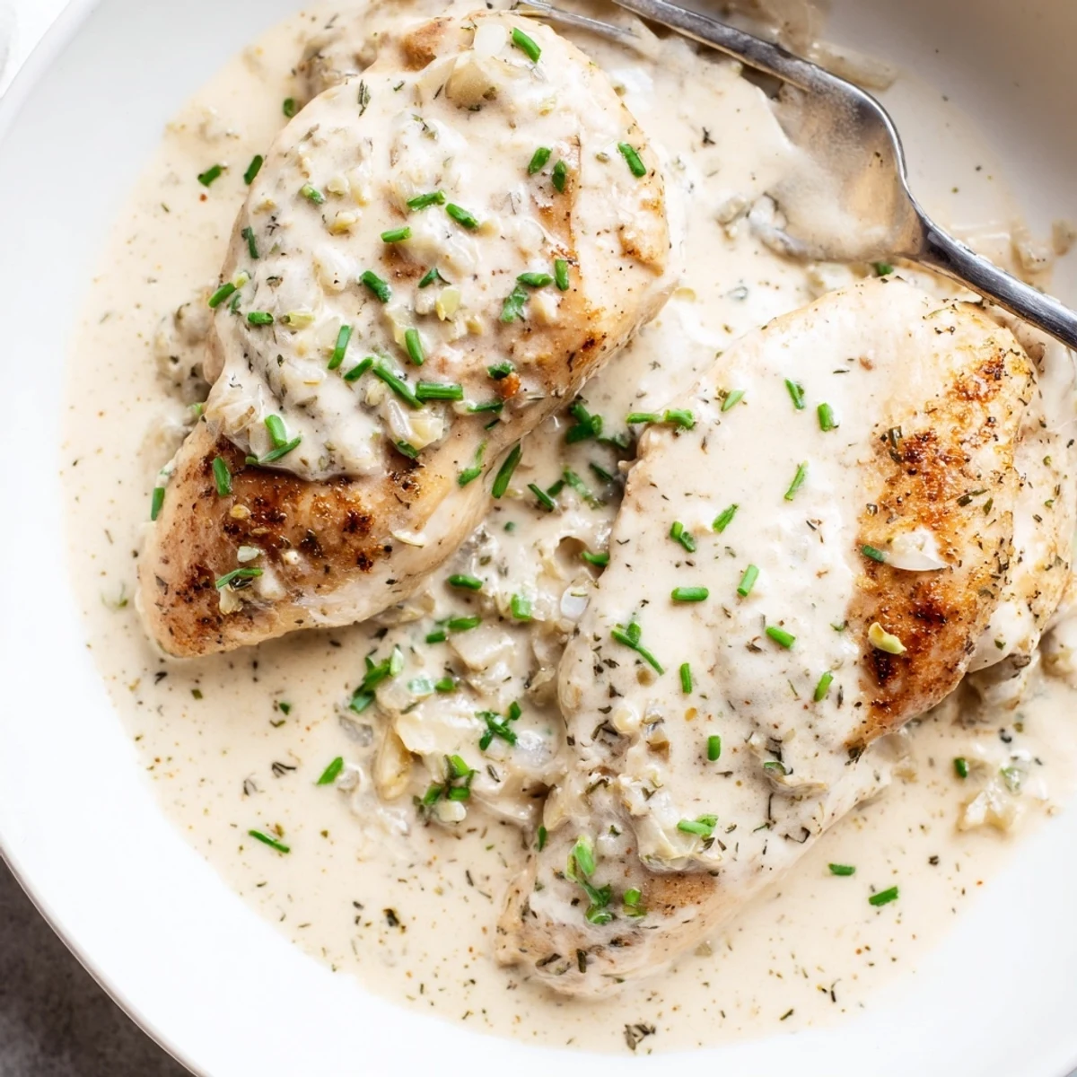 Cream cheese chicken with tender golden seared breasts in velvety herb sauce